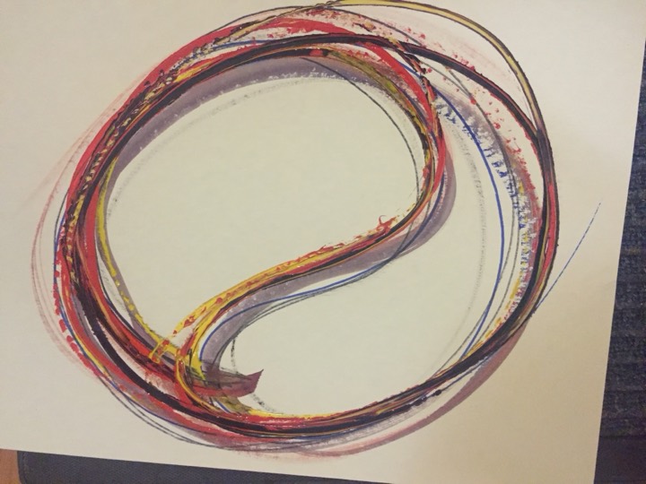 A circular sweep of red, violet and yellow with a flowing centre.